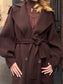 Cappotto con manica a sbuffo e cintura
